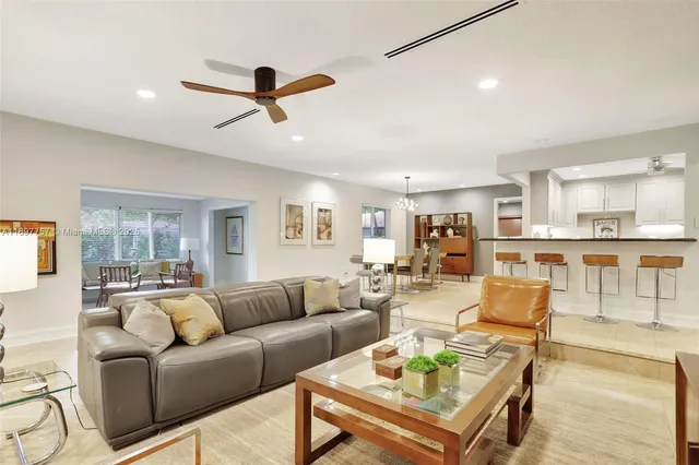 a living room with furniture and kitchen view