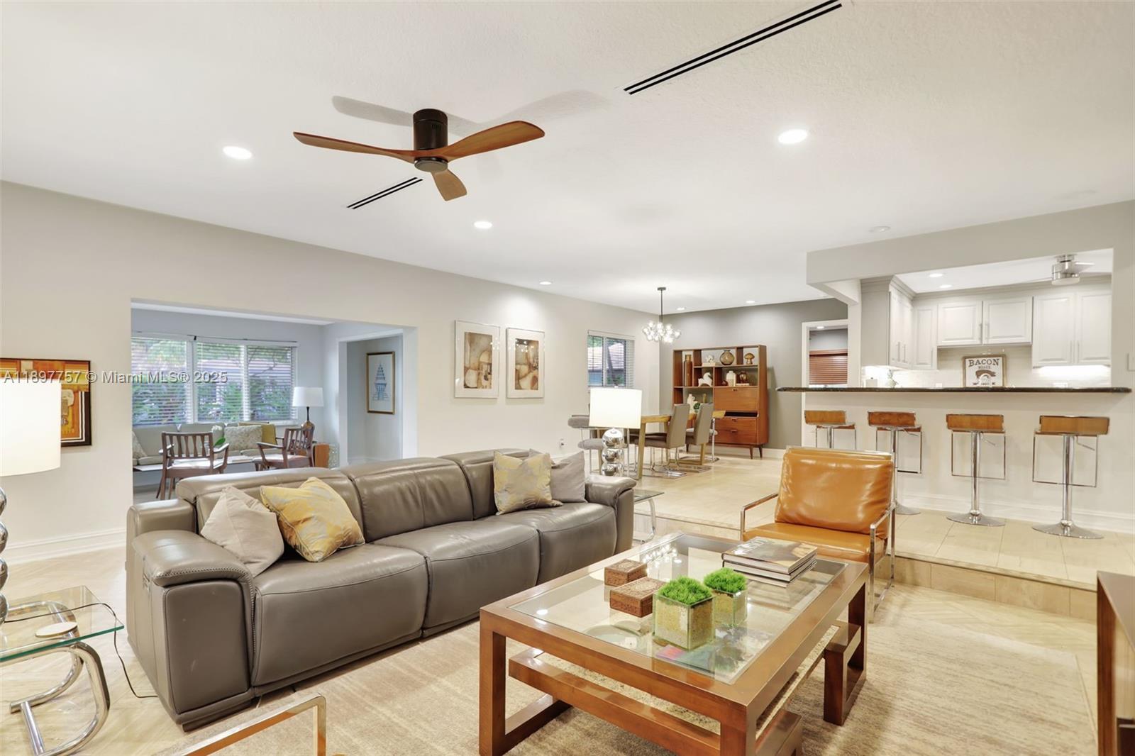1128 West Cypress Drive, Unit V15 Pompano Beach, FL 33069 - Photo 2 of 41 a living room with furniture and kitchen view