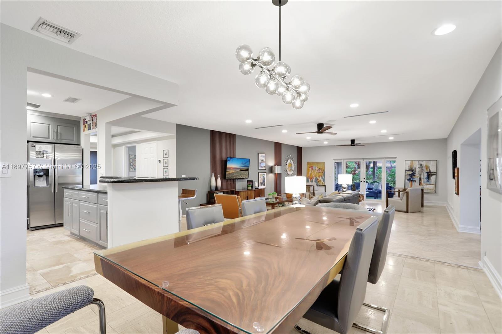 1128 West Cypress Drive, Unit V15 Pompano Beach, FL 33069 - Photo 22 of 41 a view of a dining room and livingroom with furniture wooden floor a chandelier