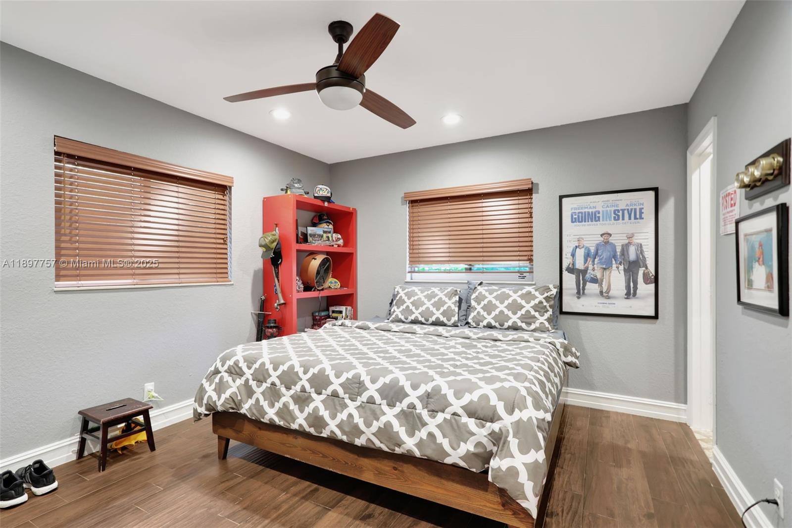 1128 West Cypress Drive, Unit V15 Pompano Beach, FL 33069 - Photo 24 of 41 a bedroom with a bed and a chandelier