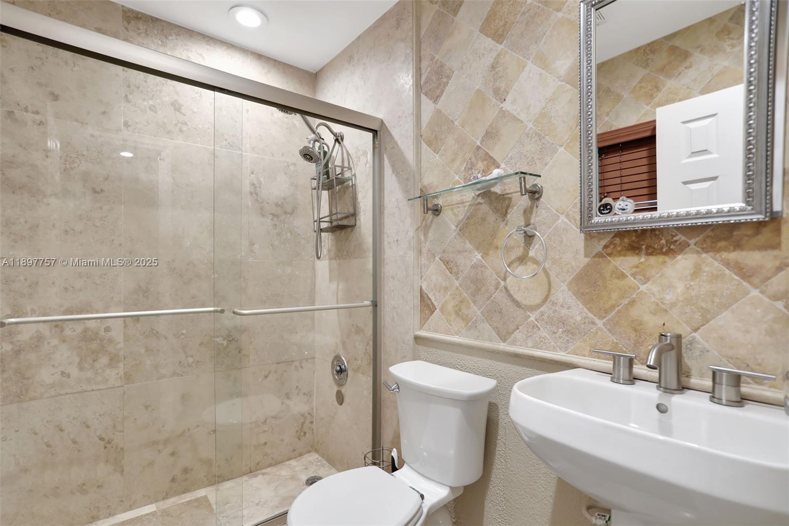 1128 West Cypress Drive, Unit V15 Pompano Beach, FL 33069 - Photo 25 of 41 a bathroom with a sink toilet and shower