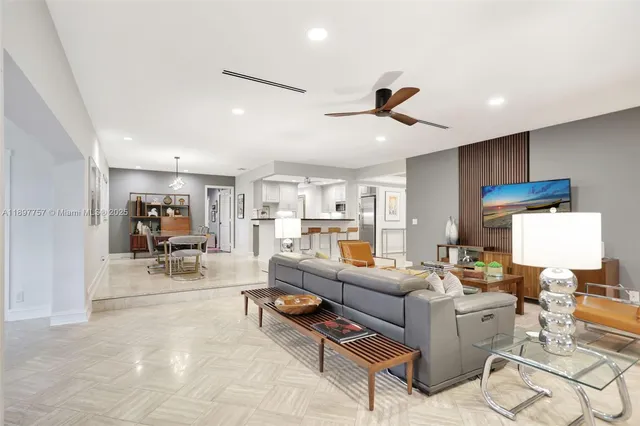 a living room with furniture and kitchen view