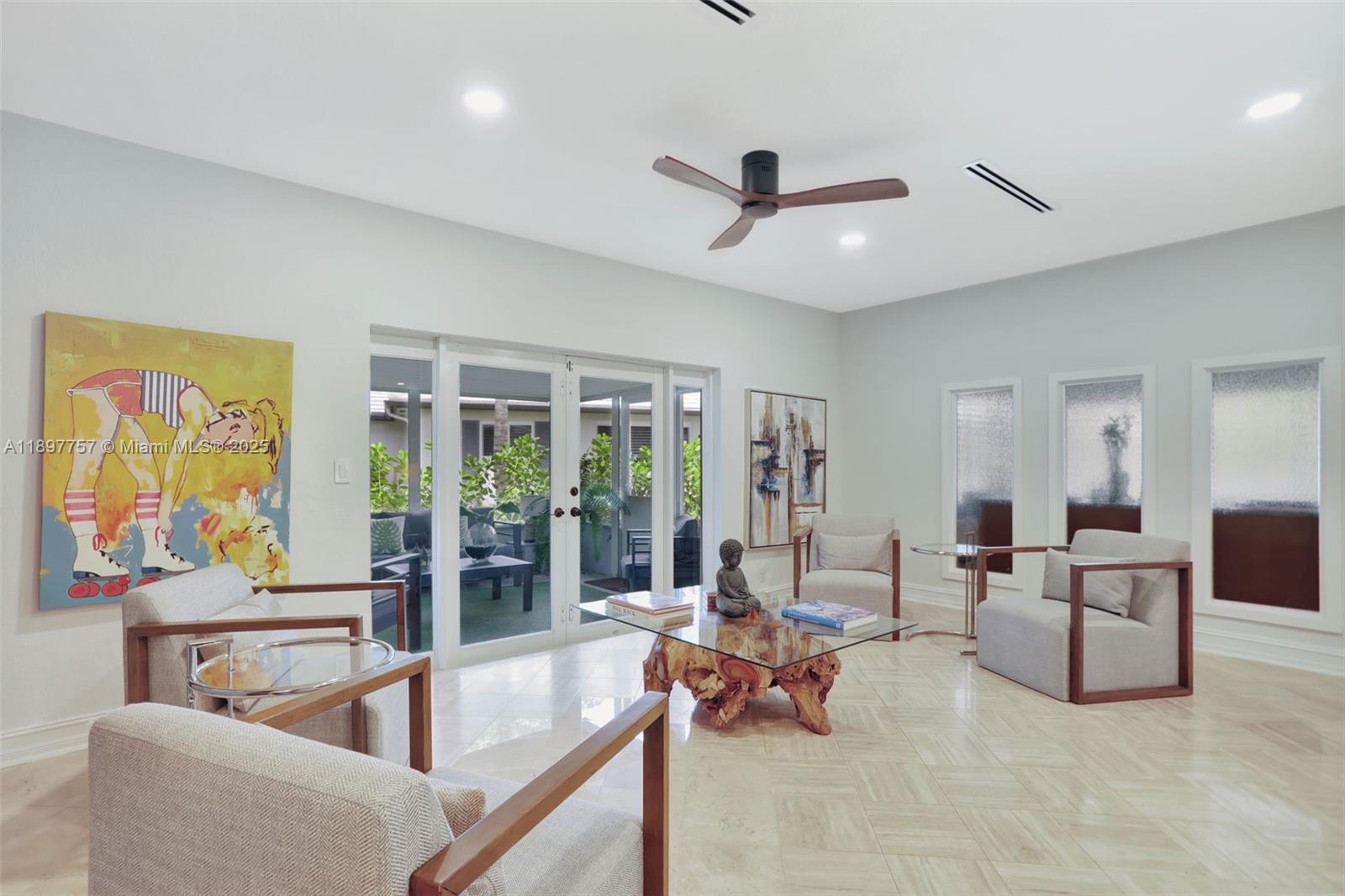 1128 West Cypress Drive, Unit V15 Pompano Beach, FL 33069 - Photo 29 of 41 a living room with furniture and a large window