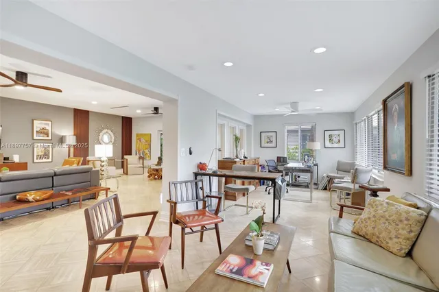 a living room with lots of furniture and view of kitchen