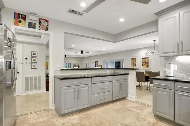 a kitchen with sink and cabinets