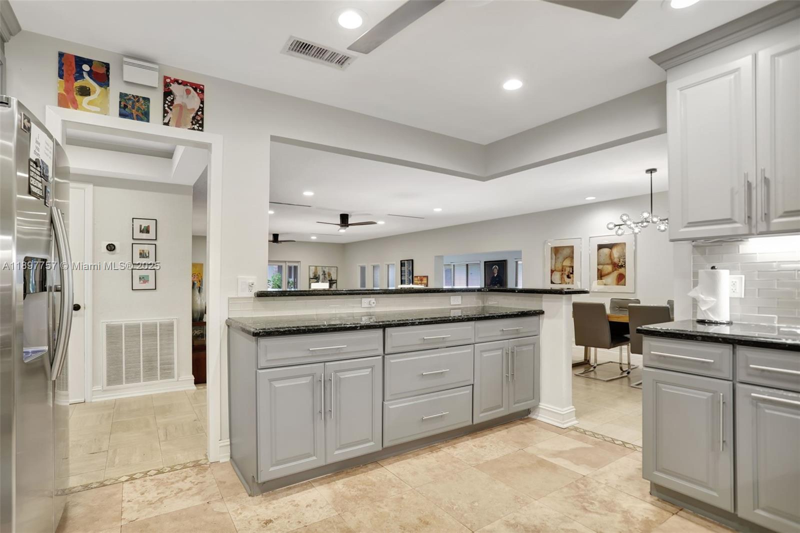 1128 West Cypress Drive, Unit V15 Pompano Beach, FL 33069 - Photo 10 of 41 a kitchen with sink and cabinets