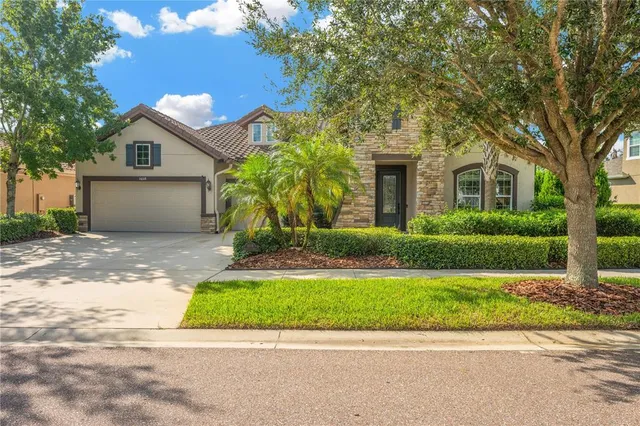 a front view of a house with a yard and garage