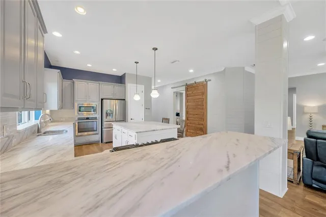 a kitchen with granite countertop white cabinets and white appliances