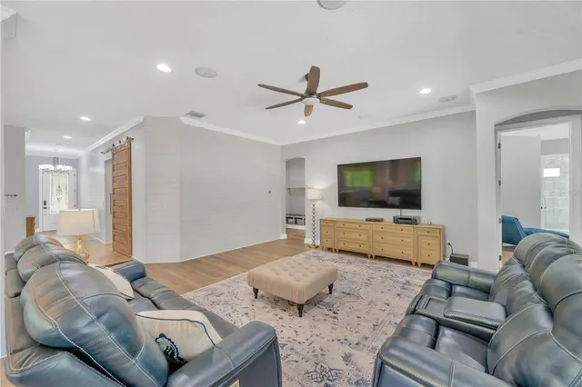 a bedroom with a bed and a ceiling fan