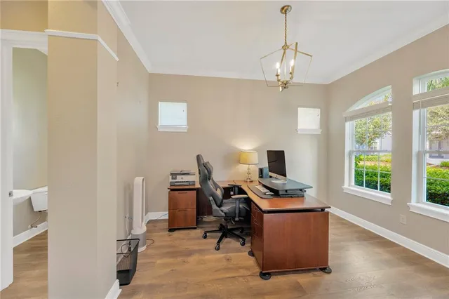 a room with a dresser and a chandelier