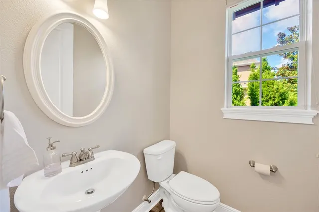 a bedroom with a large bed a flat tv screen and a dresser