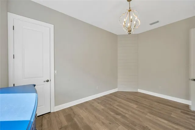 a view of a kitchen with kitchen island a large window cabinets a sink and a refrigerator