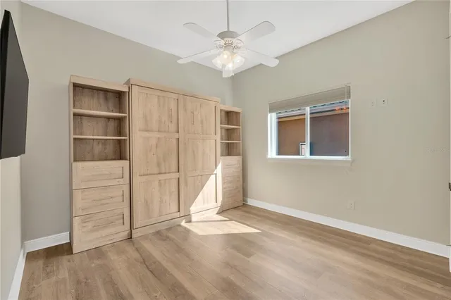 a view of livingroom with fireplace fan and windows