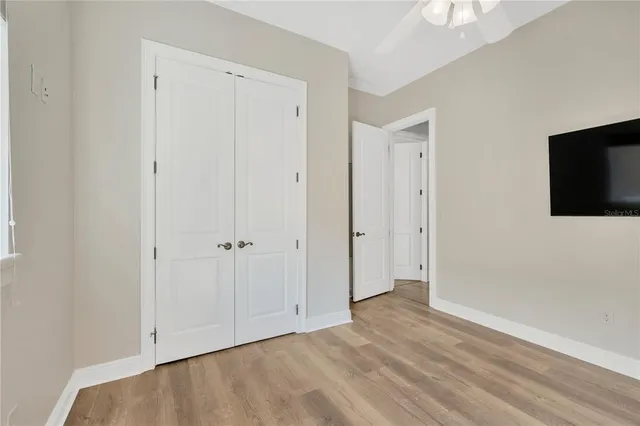 a view of an empty room with a fireplace and a window