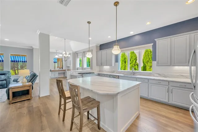 a open kitchen with wooden floor and window
