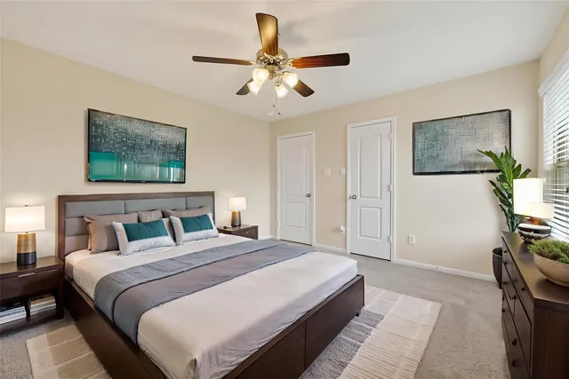 a bedroom with a large bed and a chandelier