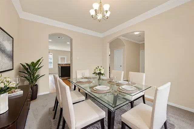 a view of a dining room with furniture and chandelier