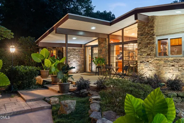 a view of deck with furniture and a garden