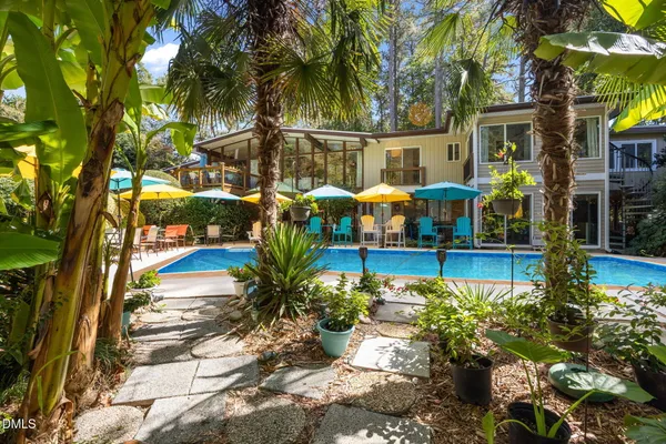 a view of a swimming pool with a patio and a garden