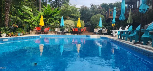 a living room with furniture a flat screen tv and floor to ceiling window