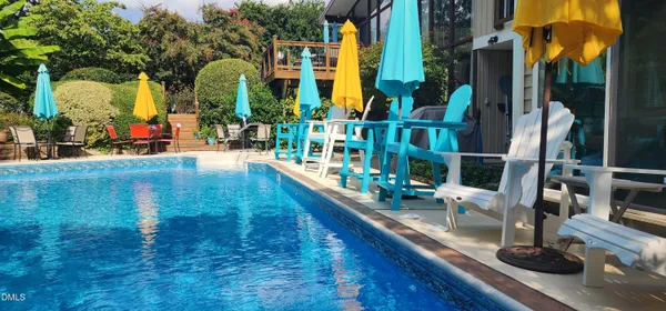 a living room with furniture a fireplace and a large window
