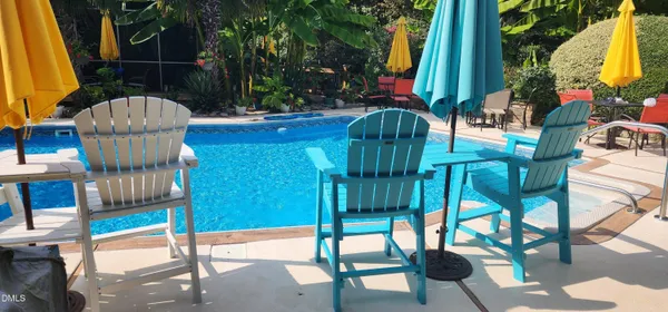 a living room with fireplace furniture and a large window