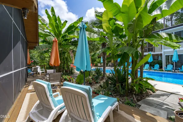 a living room with fireplace furniture and a large window