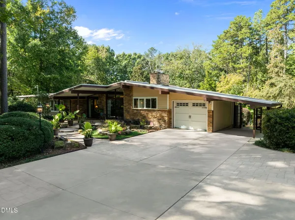 a view of a house with sitting area and garden