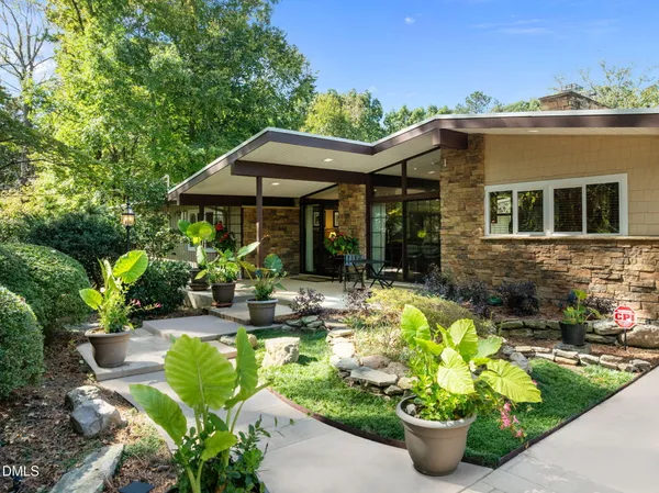 a front view of a house with a garden
