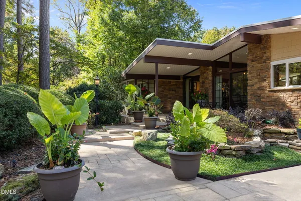 a view of a porch with chairs and backyard