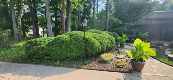 a view of a house with backyard sitting area and garden