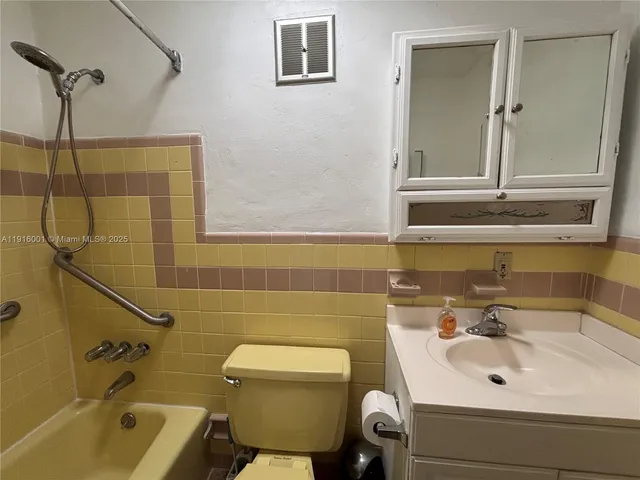 a bathroom with a sink and mirror with toilet