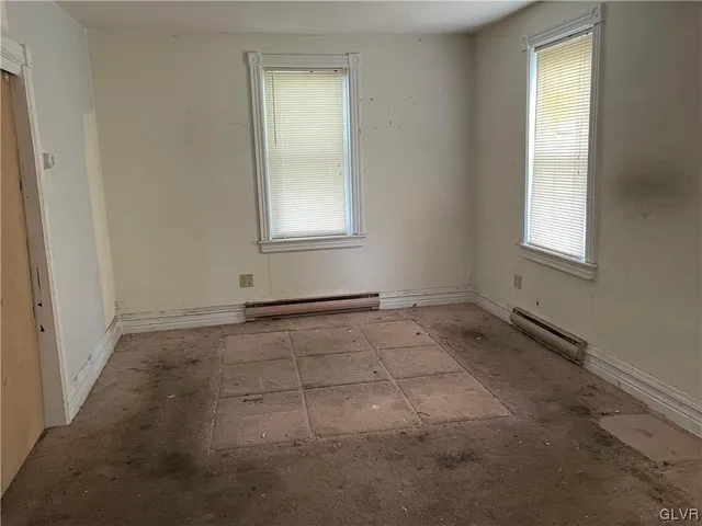 an empty room with a empty space and windows