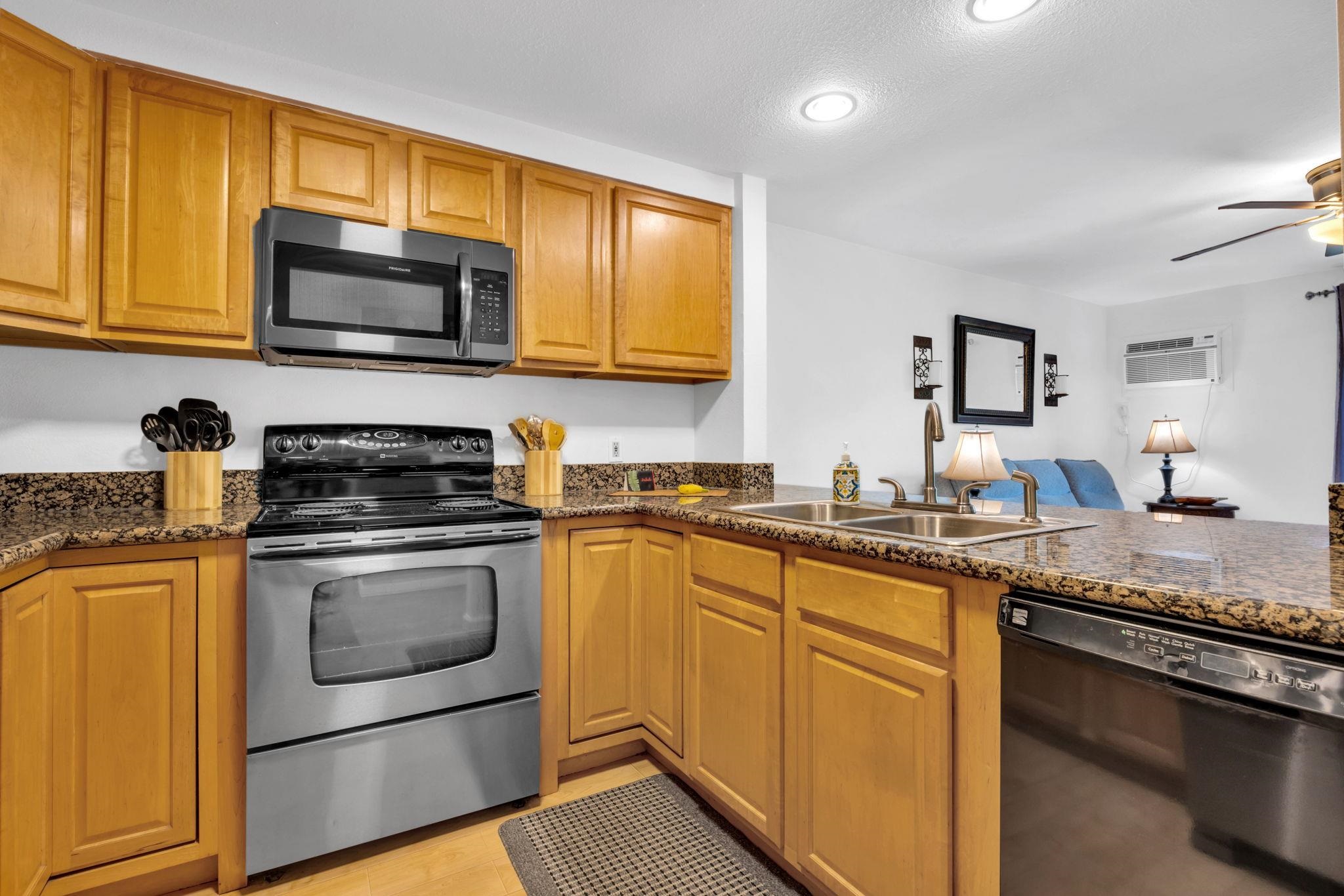 2747 South Kihei Road, Unit C205 Kihei, HI 96753 - Photo 14 of 49 a kitchen with stainless steel appliances granite countertop a sink stove microwave and refrigerator