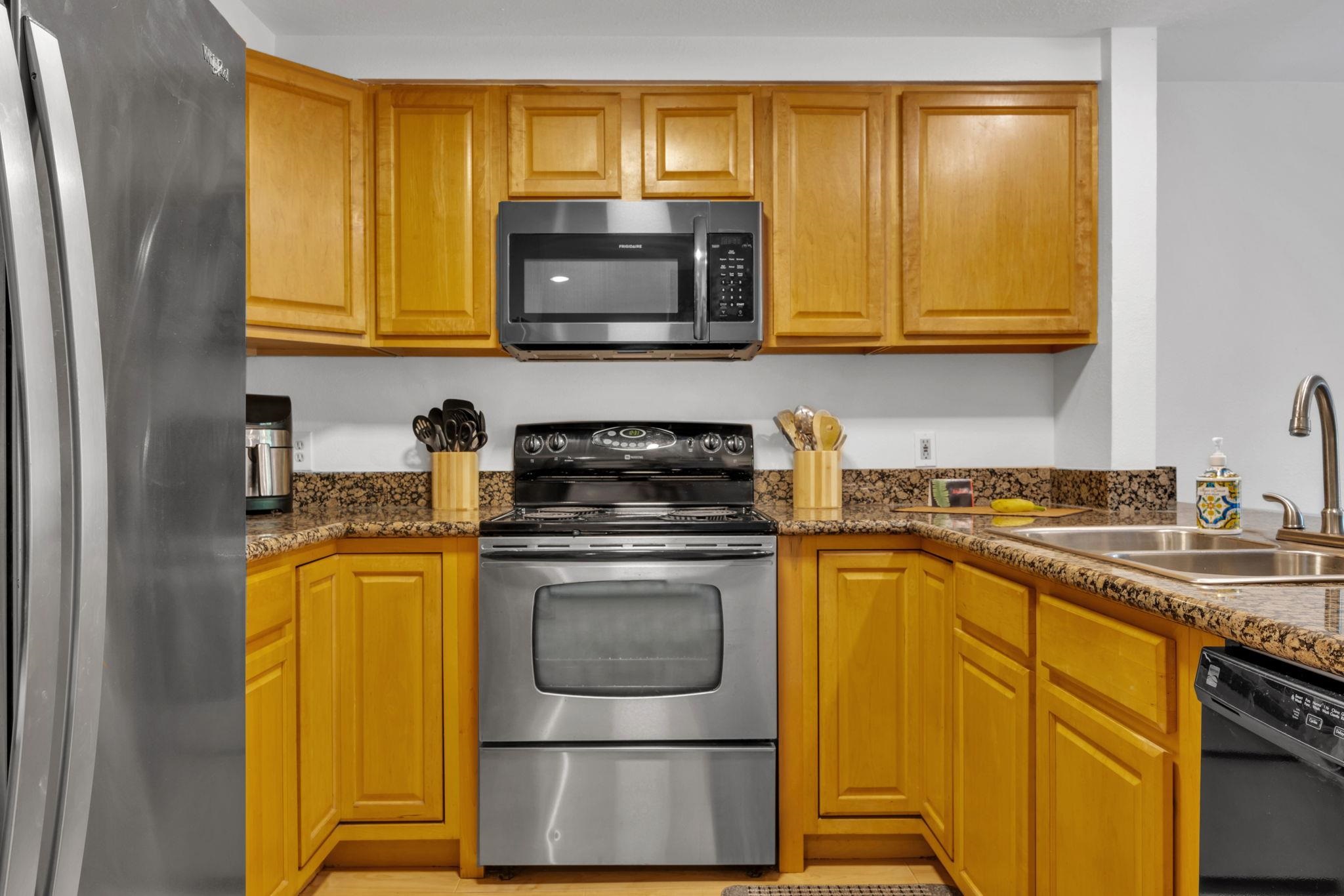 2747 South Kihei Road, Unit C205 Kihei, HI 96753 - Photo 15 of 49 a kitchen with stainless steel appliances granite countertop a stove a sink and a microwave