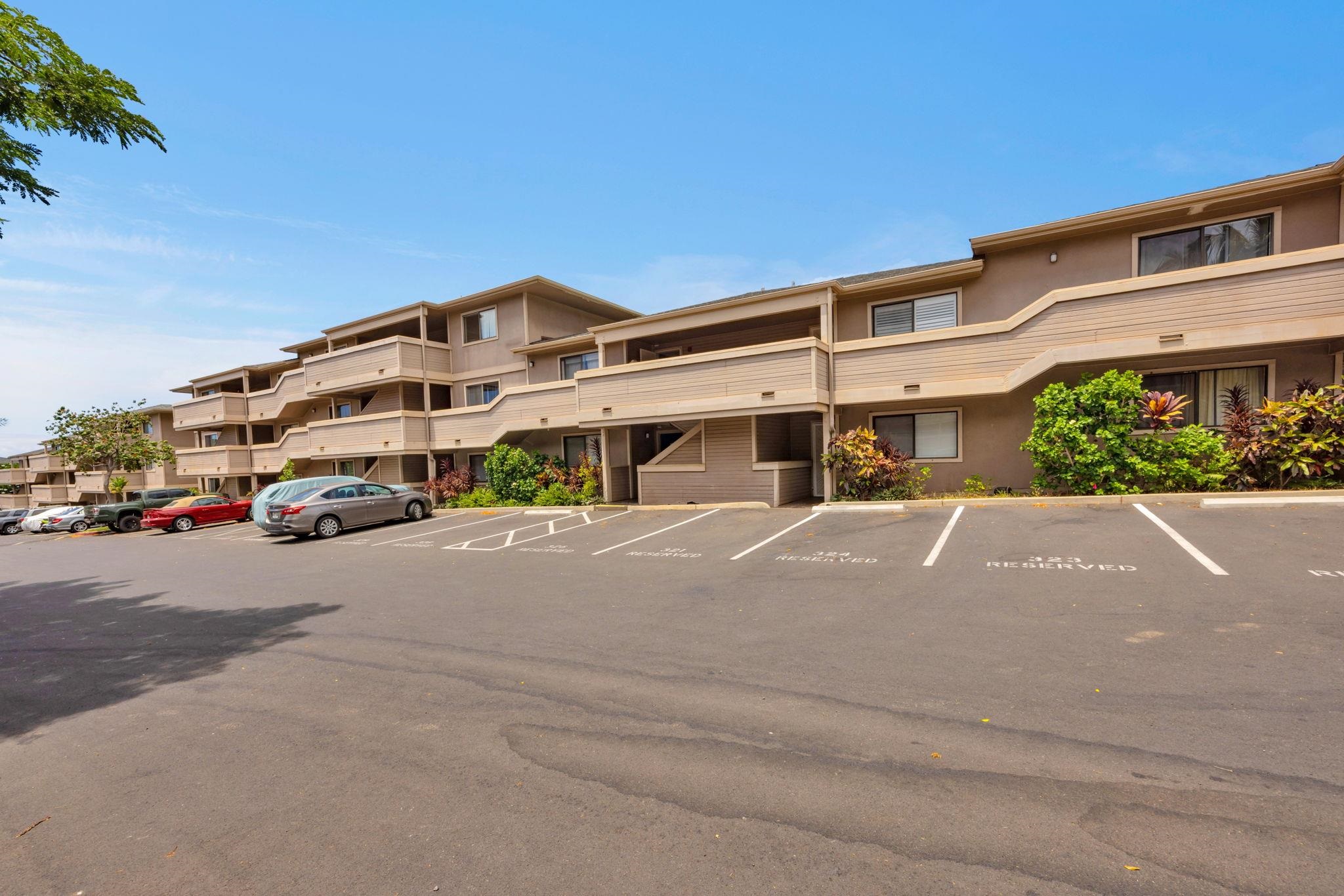 2747 South Kihei Road, Unit C205 Kihei, HI 96753 - Photo 33 of 49 a front view of a house with a yard and garage