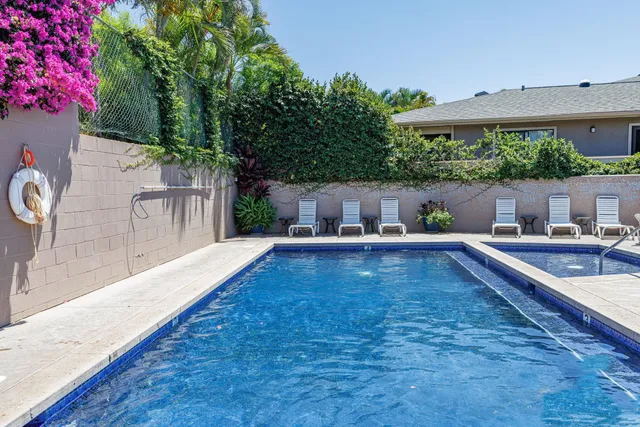 a vase of flowers sitting on a table with window