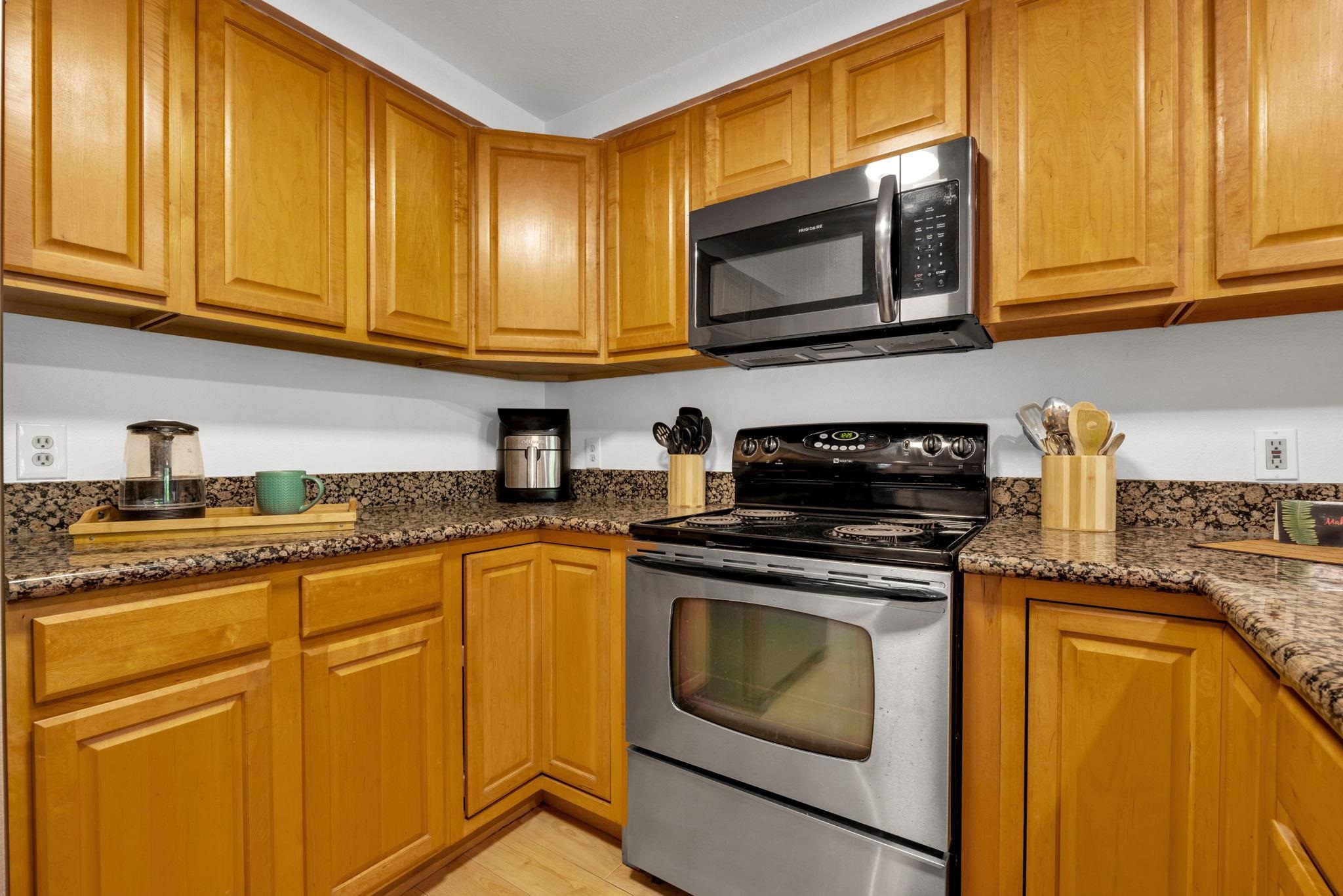 2747 South Kihei Road, Unit C205 Kihei, HI 96753 - Photo 6 of 49 a kitchen with granite countertop cabinets stainless steel appliances granite countertop white cabinets granite counter tops and a window