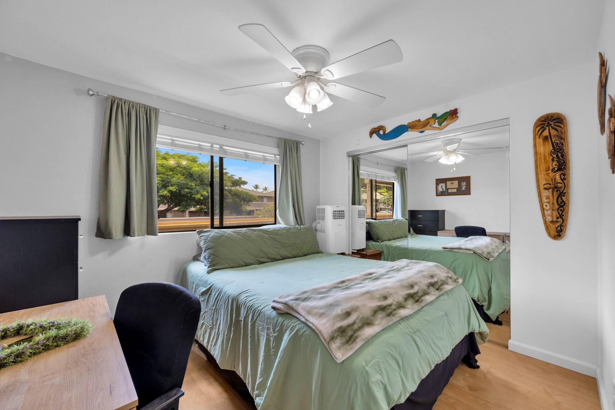 2747 South Kihei Road, Unit C205 Kihei, HI 96753 - Photo 8 of 49 a bedroom with a bed and a large mirror with a large window