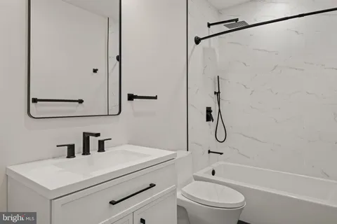 a bathroom with a shower a toilet and a sink