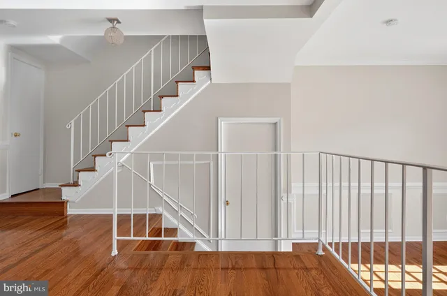 a view of entryway and hall with wooden floor