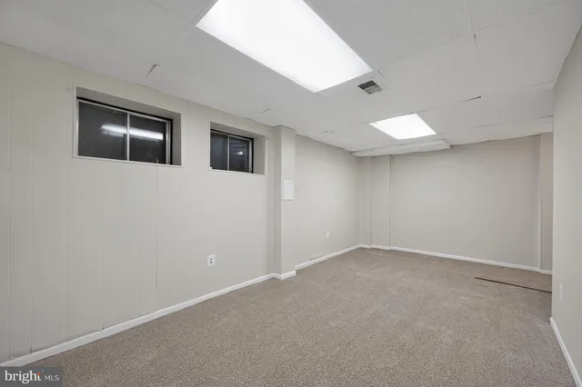 an empty room with a bathroom and a sink