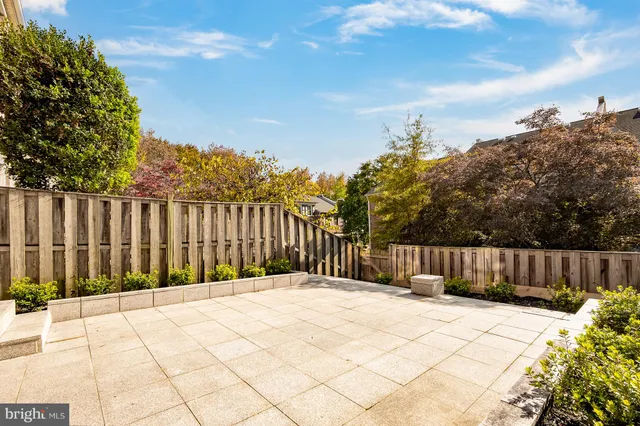 a view of a house with wooden fence