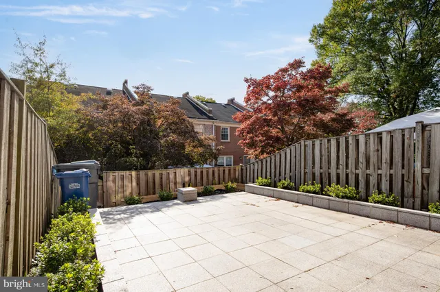 a view of a backyard with wooden fence