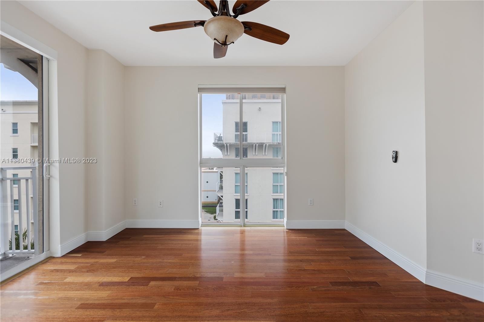 7290 Southwest 90th Street, Unit F606 Miami, FL 33156 - Photo 11 of 17 wooden floor in an empty room with a window
