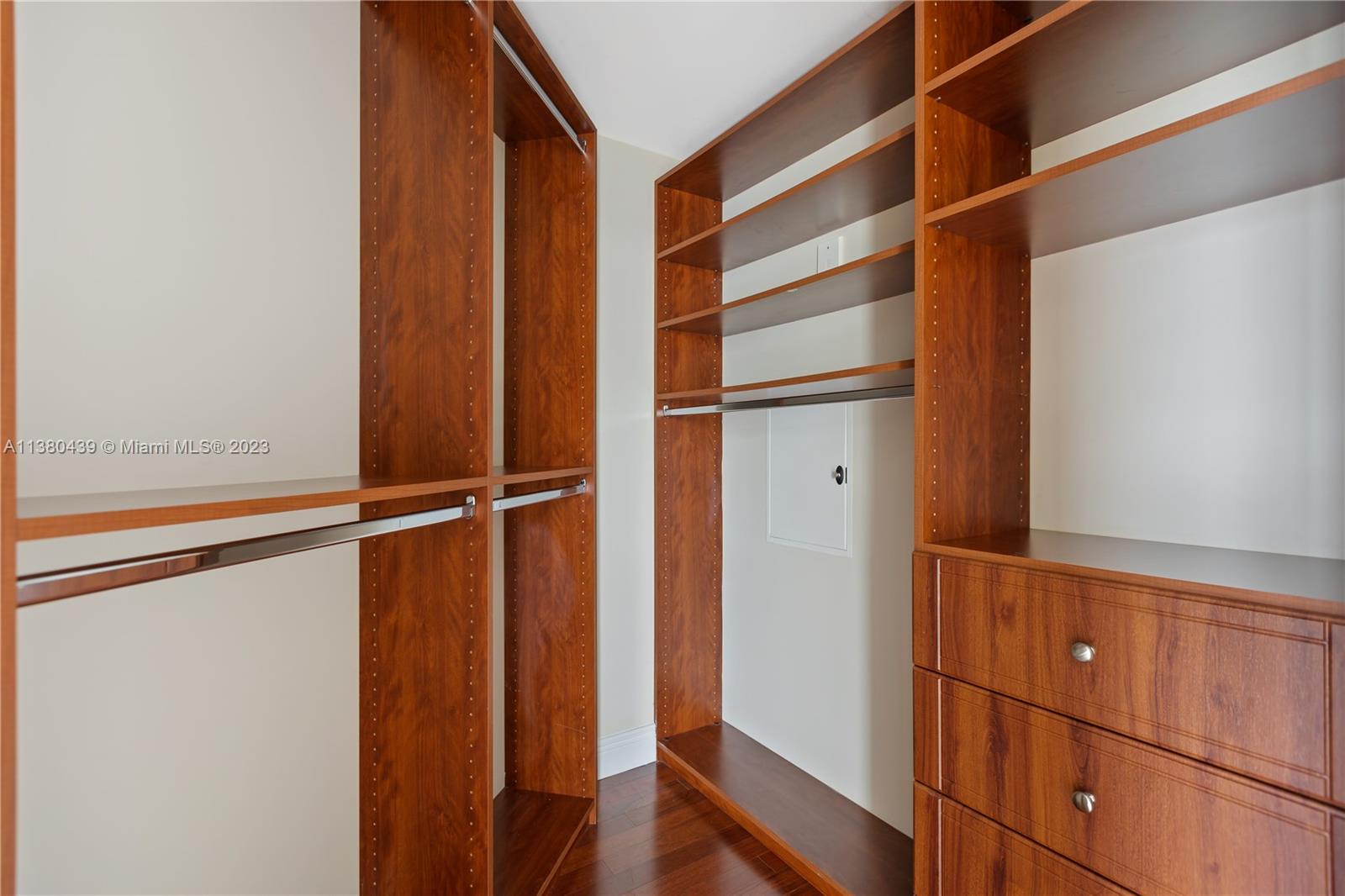 7290 Southwest 90th Street, Unit F606 Miami, FL 33156 - Photo 12 of 17 a view of walk in closet with empty racks