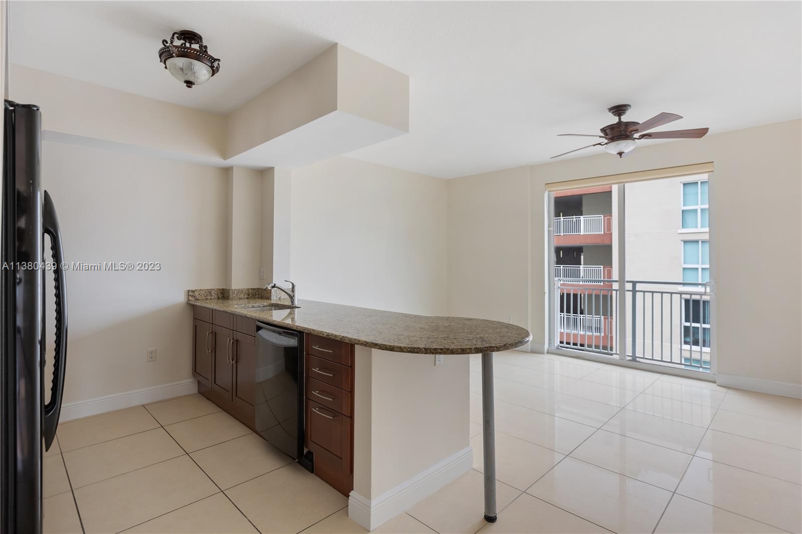 7290 Southwest 90th Street, Unit F606 Miami, FL 33156 - Photo 2 of 17 a kitchen with stainless steel appliances granite countertop a stove and a refrigerator