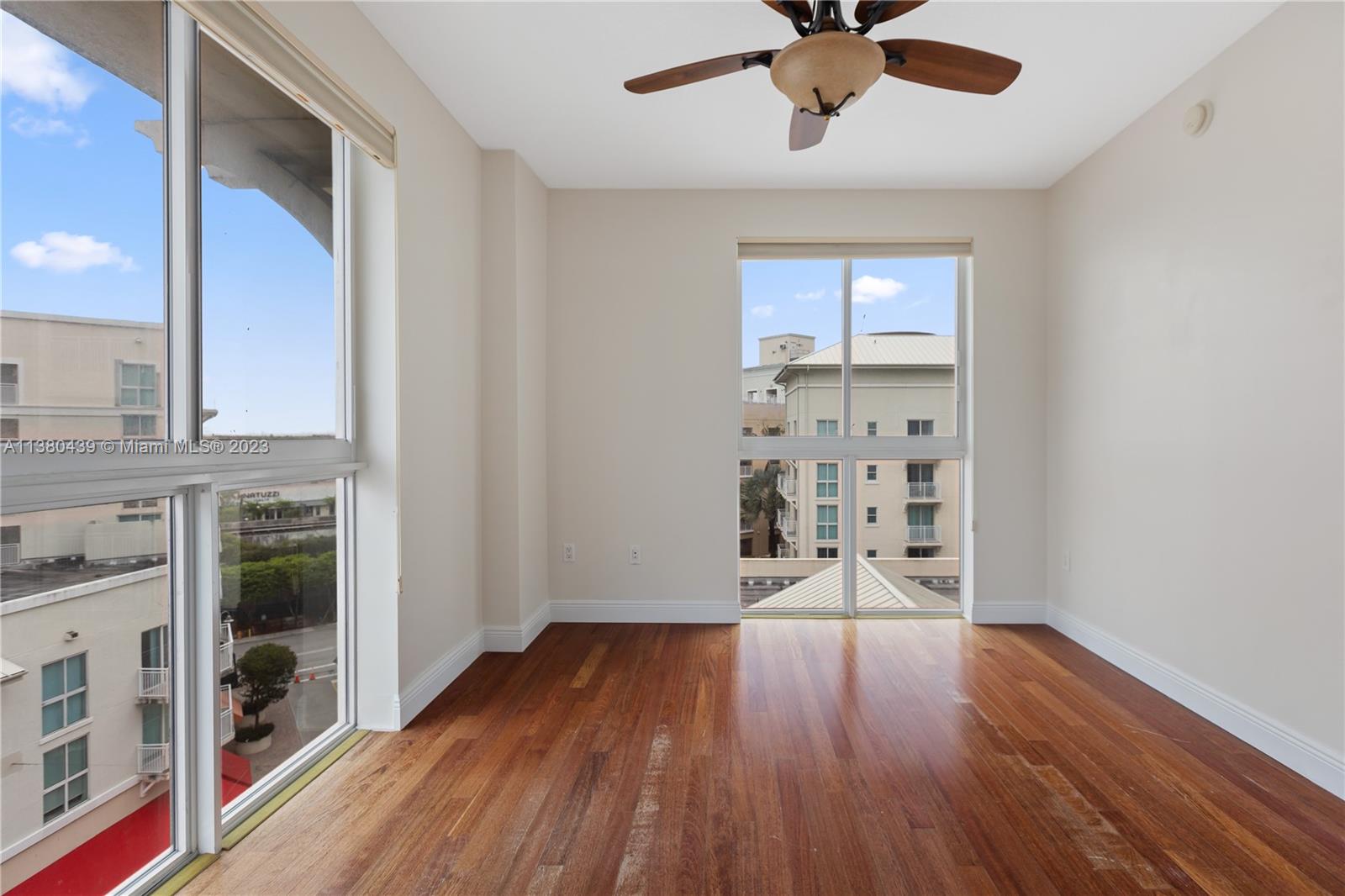 7290 Southwest 90th Street, Unit F606 Miami, FL 33156 - Photo 7 of 17 a view of wooden floor and a chandelier fan in a room