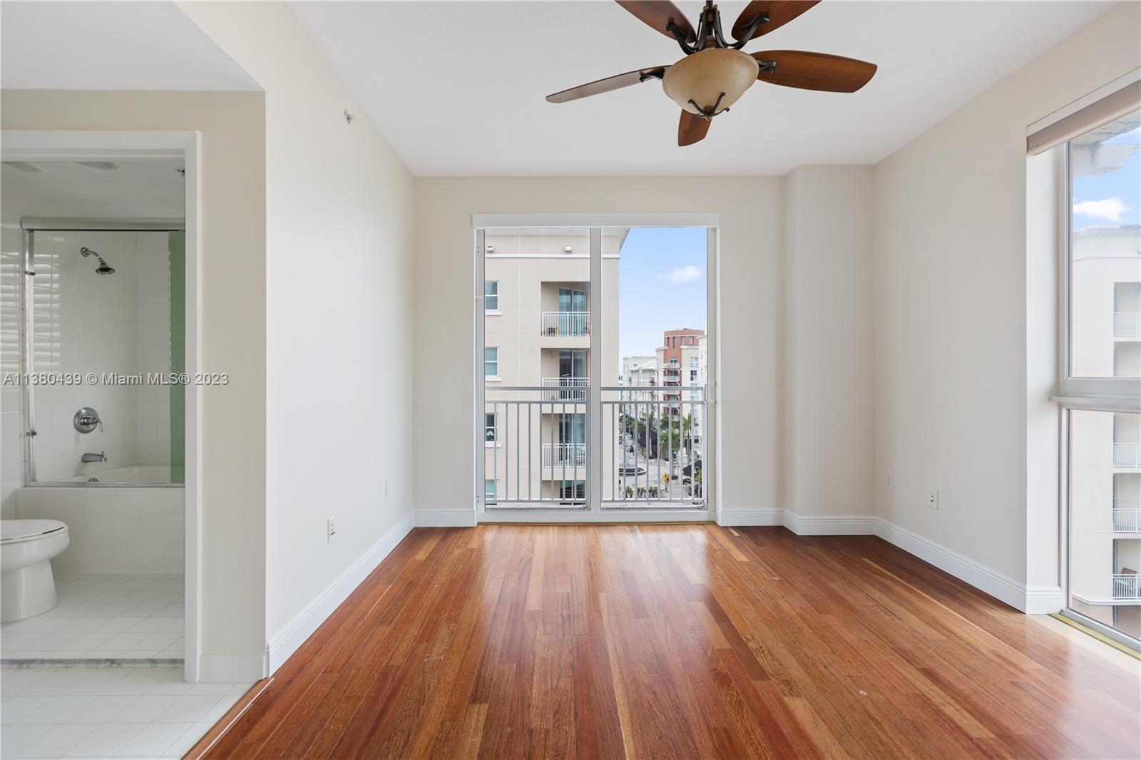 7290 Southwest 90th Street, Unit F606 Miami, FL 33156 - Photo 9 of 17 a view of a hallway with wooden floor and a bathroom