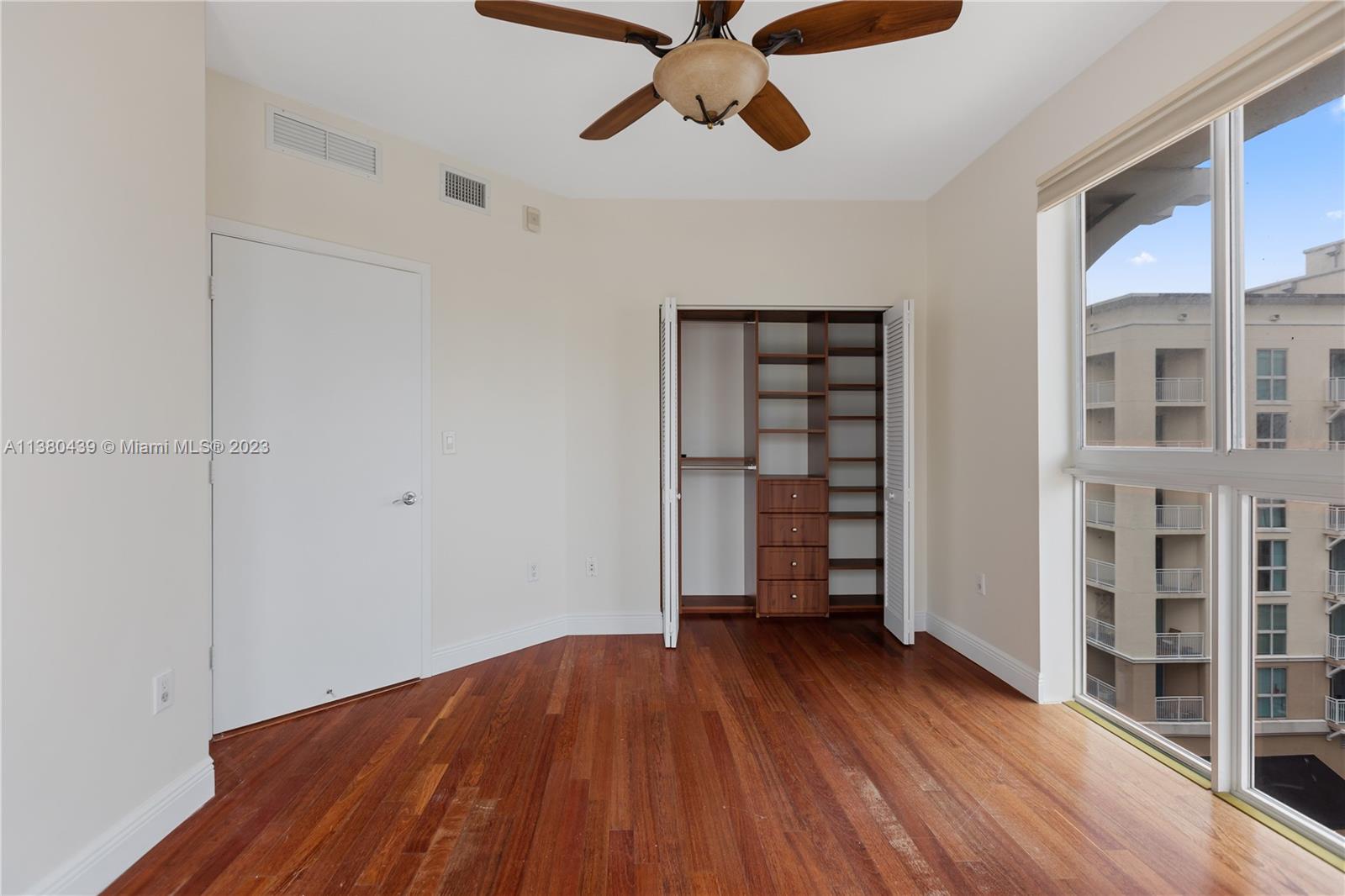 7290 Southwest 90th Street, Unit F606 Miami, FL 33156 - Photo 10 of 17 wooden floor in an empty room with a window